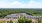 an arial shot of a building surrounded by trees