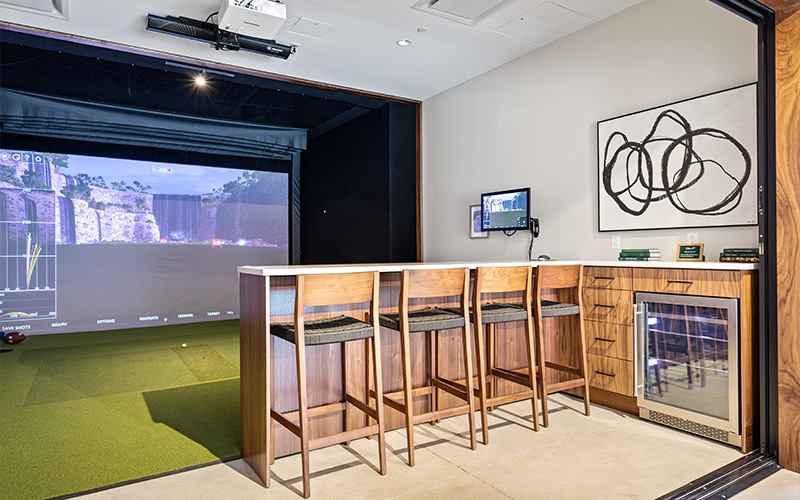 a room with a golf simulator game