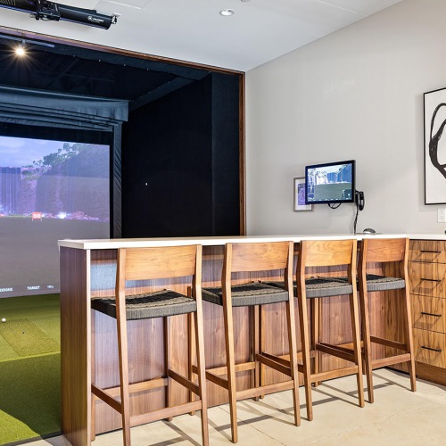 Golf Simulator countertop with barstools facing golf simulator screen